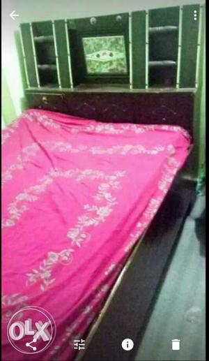 Single wooden bed without metresses