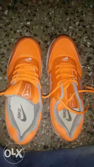 Pair Of Orange Nike Running Shoes