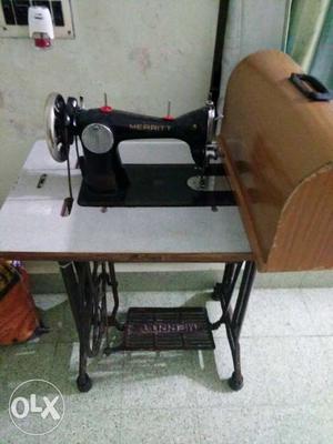 Black Threadle Sewing Machine And Brown Wooden Case