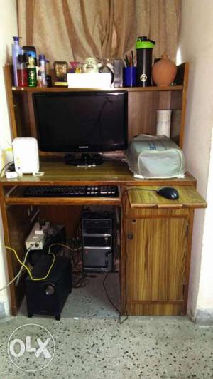 Brown Wooden Computer Desk And Black Corded Mouse