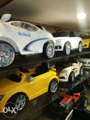 Four White And Yellow Toy Cars