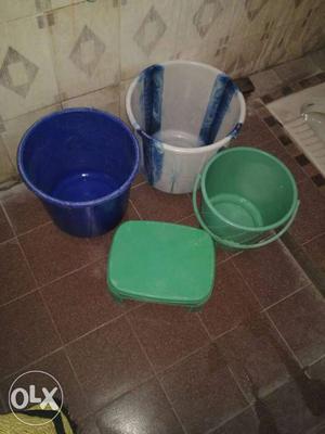 Three Blue, White, And Green Plastic Pails And Green Stool