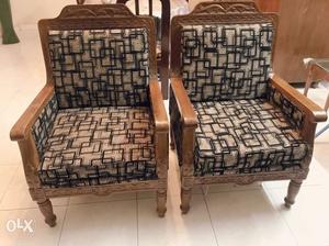 Two Brown Wooden Framed Black And White Padded Armchairs