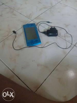Blue Game Console With Black Charger