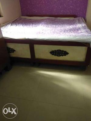 Double bed with mattress. The bed has a utility