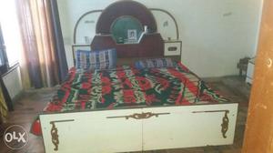 White And Brown Wooden Bed Frame With Red And Green Mattress