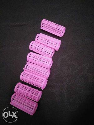 A set of 8 hair curlers.