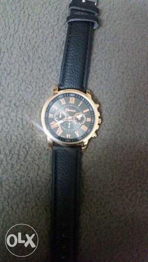 Geneva gold and black face watch. band is leather