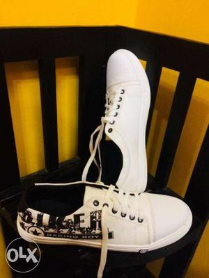 Pair Of White-and-black Low-top Sneakers