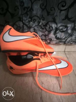 Pair Of Orange Nike Cleats size 5