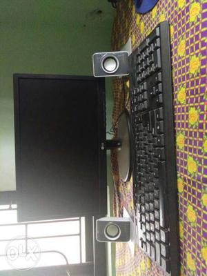 Black LG Computer Monitor; black Desktop Speakers; Black