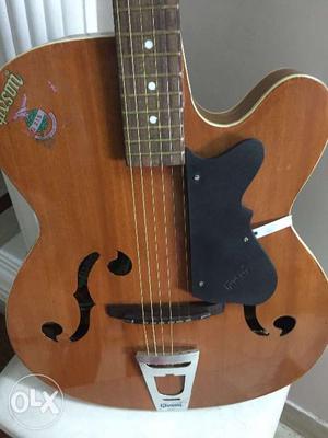 Givson guitar with new strings, brown polish,