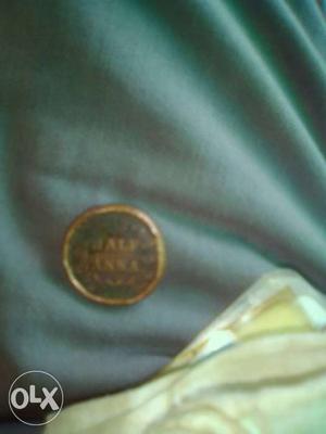 Round Gold-colored Half Anna Coin