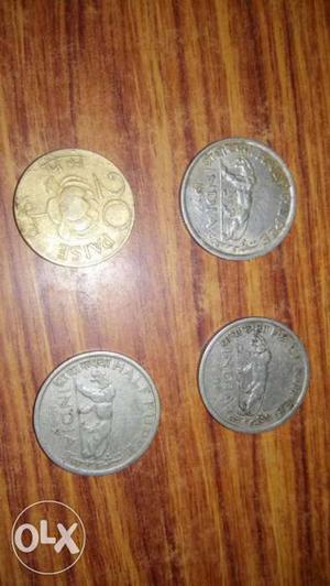 Three Round Silver-colored And One Gold-colored Coins