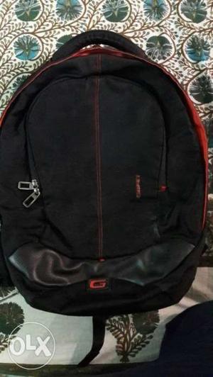 Gear black coloured backpack with red lining