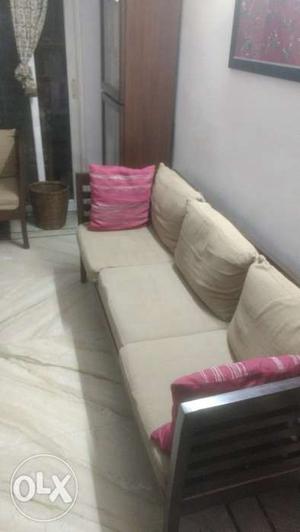 A teak wood sofa in prime condition and in 3+1+1