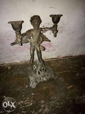 Angel Holding Two Gray Concrete Candle Holders