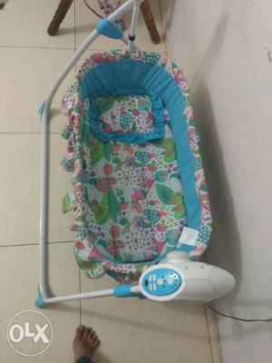 Baby's Blue, White, Pink, And Green Fabric Cradle