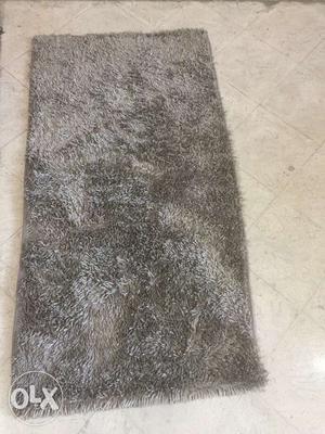 Light green and grey fur rug. Good condition