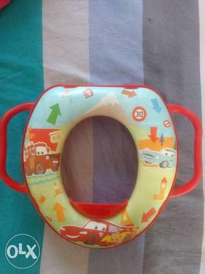 Toddler's Green, Orange, And Blue Potty Trainer Seat