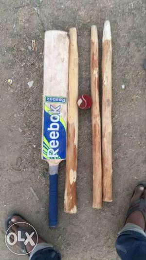 Beige And Blue Reebok Cricket Bat And Stamps