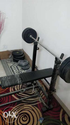 Gym bench and lot of weights. One box full of weights