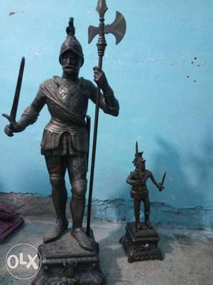 Man In Knight's Armor Holding Sword And Battle Axe Statue