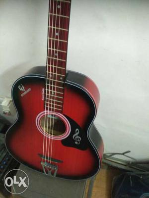 Red and black Dreadnought acoustic guitar,