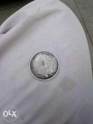 Round Silver-colored Man's Profile Coin