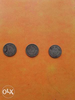 Three Round Silver-colored 25 Indian Paise Coins