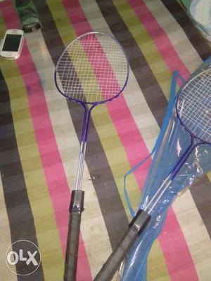 Two Gray-and-blue Badminton Rackets With Case