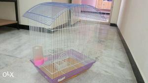 Bird cage spacious,violet colour with food and