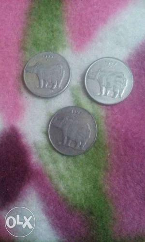 Three Silver-colored 25 Indian Paise Coins