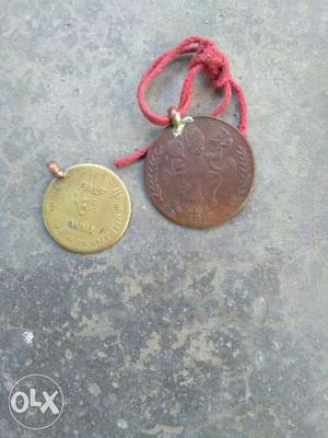 Two Round Gold-colored And Copper-colored Coin Pendants