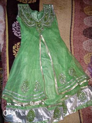 Green coloured frock suit provides royal look