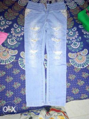 Light blue colour denim jeans with golden patch