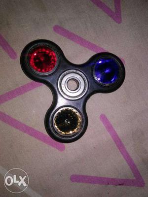Black, Gold, Blue, And Red Hand Spinner