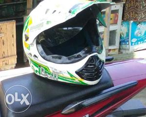 Green, Yellow, And White Motocross Helmet