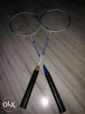 Two White-and-blue Badminton Rackets