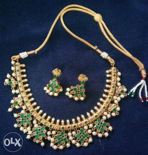 Green stone with white polki and pearls set..