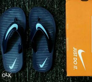 Pair Of Black-and-white Striped Nike Flip Flops