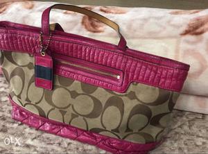 Pink Coach tote, with two zippers. Bag has been