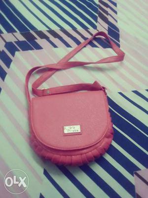 Branded new red sling side bag at the lowest