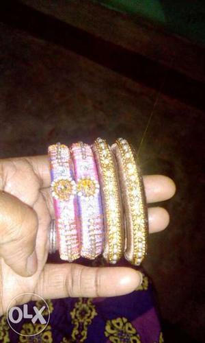 Two Pairs Of Pink And Gold Silk Threaded Bangles