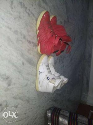 Two Pairs Of Red And White Basketball Shoes