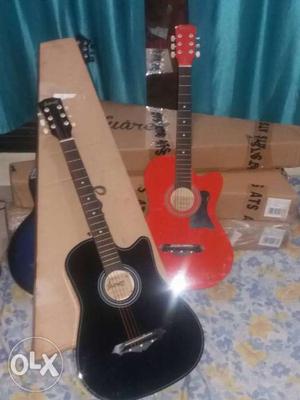 Two Black And Red Acoustic Guitars