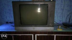 Gray CRT TV With Brown Wooden TV Hutch