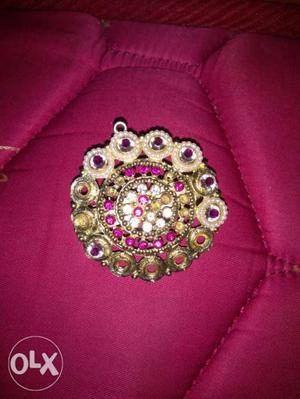 Round Gold-colored Pink Gemstone Encrusted Amulet
