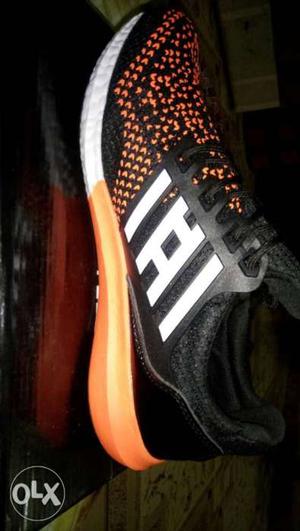 paired Black And Orange Running Shoe