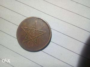 Round Gold-colored Star Embossed Coin